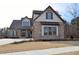 Charming two-story home with a brick facade, covered entryway, and manicured lawn at 1670 Knob Creek Nw Ct, Acworth, GA 30101
