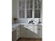 Bright laundry room features white cabinetry, quartz countertops and a lovely window view at 1670 Knob Creek Nw Ct, Acworth, GA 30101