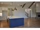 Open concept living room with hardwood floors, fireplace, and kitchen island at 1670 Knob Creek Nw Ct, Acworth, GA 30101