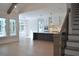 Open concept living space with vaulted ceilings, hardwood floors, a large island, and staircase at 1670 Knob Creek Nw Ct, Acworth, GA 30101