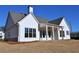 The rear exterior features white siding, a covered porch and a well-manicured lawn at 1670 Knob Creek Nw Ct, Acworth, GA 30101