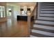 Hardwood staircase with wrought iron railings, leading to an open concept living area and kitchen at 1670 Knob Creek Nw Ct, Acworth, GA 30101