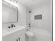 Bathroom with white marble tile, black matte hardware, shower and tub at 1690 Eaglecreek Trl, Cumming, GA 30041