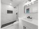 Bathroom with walk in shower, black matte hardware, marble wall tile, sink and vanity at 1690 Eaglecreek Trl, Cumming, GA 30041