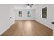 Bright bedroom with hardwood floors, three windows, ceiling fan, and neutral walls at 1690 Eaglecreek Trl, Cumming, GA 30041
