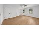 Bright bedroom with hardwood floors, three windows, ceiling fan, and neutral walls at 1690 Eaglecreek Trl, Cumming, GA 30041