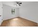 Bedroom with hardwood floors, one window, ceiling fan, and neutral walls at 1690 Eaglecreek Trl, Cumming, GA 30041