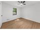 Bedroom with hardwood floors, one window, ceiling fan, and neutral walls at 1690 Eaglecreek Trl, Cumming, GA 30041