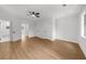 Bright bedroom with hardwood floors, ceiling fan, bathroom entrance, and three windows at 1690 Eaglecreek Trl, Cumming, GA 30041