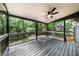 Large, covered deck features a ceiling fan overlooking a treed backyard at 1690 Eaglecreek Trl, Cumming, GA 30041