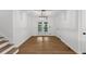 Dining room features a modern light fixture and french doors leading to the backyard at 1690 Eaglecreek Trl, Cumming, GA 30041