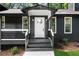 Welcoming front porch with classic white trim and a decorative front door at 1690 Eaglecreek Trl, Cumming, GA 30041