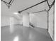 Spacious two car garage with epoxy flooring and an electric door at 1690 Eaglecreek Trl, Cumming, GA 30041