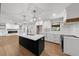 Spacious kitchen design featuring a black island, bright white cabinets, and stainless appliances at 1690 Eaglecreek Trl, Cumming, GA 30041