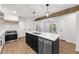 Open kitchen with stainless steel appliances, island with a sink and stone countertops at 1690 Eaglecreek Trl, Cumming, GA 30041