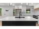 Bright kitchen features a black island, stylish lighting and an open design concept at 1690 Eaglecreek Trl, Cumming, GA 30041