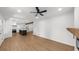 Bright and airy living room features a fireplace, modern ceiling fan and new flooring at 1690 Eaglecreek Trl, Cumming, GA 30041