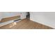 Spacious room with hardwood floors and an accent built-in bench at 1690 Eaglecreek Trl, Cumming, GA 30041