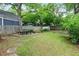 A spacious backyard featuring a picnic table, green grass, a wooden fence, and convenient storage sheds at 343 Josephine Ne St, Atlanta, GA 30307