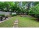 A beautiful fenced backyard includes a stone path, picnic table, small garden, and storage shed at 343 Josephine Ne St, Atlanta, GA 30307