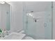Bright bathroom featuring a shower with white subway tile surround, built-in shelving, and stone floor at 343 Josephine Ne St, Atlanta, GA 30307