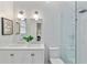 Bright bathroom featuring a double sink vanity, framed mirror, and glass-enclosed shower with subway tile surround at 343 Josephine Ne St, Atlanta, GA 30307
