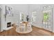 Airy dining area features a stylish brick fireplace, bright windows, and access to the front porch at 343 Josephine Ne St, Atlanta, GA 30307