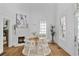 Airy dining area features a stylish brick fireplace, bright windows, and access to the front porch at 343 Josephine Ne St, Atlanta, GA 30307