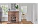 Charming brick fireplace with a mantle and view of the bright dining area at 343 Josephine Ne St, Atlanta, GA 30307