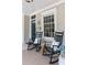 Classic rocking chairs and a welcoming rug adorn this inviting front porch with stained-glass sidelight at 343 Josephine Ne St, Atlanta, GA 30307