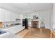 Kitchen featuring white cabinets, hardwood floors, and a brick fireplace at 343 Josephine Ne St, Atlanta, GA 30307