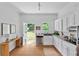 Eat-in kitchen featuring white cabinets, stainless steel appliances, hardwood floors, and a view of the backyard at 343 Josephine Ne St, Atlanta, GA 30307