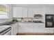 Kitchen featuring white cabinets, stainless steel appliances, and a gray countertop at 343 Josephine Ne St, Atlanta, GA 30307