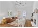 Bright living room boasts vaulted ceilings, modern lighting, fireplace, and hardwood floors at 343 Josephine Ne St, Atlanta, GA 30307