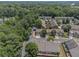Aerial view of a residential community surrounded by lush green trees and well-maintained homes at 401 Wellwood Way, Roswell, GA 30075
