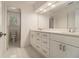 Stylish bathroom features double vanity, modern fixtures, and tiled flooring, next to powder room at 401 Wellwood Way, Roswell, GA 30075