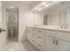 Bathroom featuring a double vanity, ample storage, and marble tile flooring at 401 Wellwood Way, Roswell, GA 30075