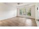 Bright bedroom with tray ceiling, ceiling fan, and three large windows at 401 Wellwood Way, Roswell, GA 30075