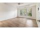 Bright bedroom featuring tray ceilings, large windows, and wood-look flooring at 401 Wellwood Way, Roswell, GA 30075