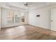 Spacious bedroom featuring a tray ceiling, fan and multiple windows at 401 Wellwood Way, Roswell, GA 30075