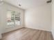 Bright bedroom with a large window offering natural light and hardwood flooring at 401 Wellwood Way, Roswell, GA 30075