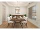 Formal dining room with natural light, wood flooring, elegant chandelier, and modern furnishings at 401 Wellwood Way, Roswell, GA 30075