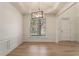 Dining area with modern chandelier, large window, hardwood floors and decorative moldings at 401 Wellwood Way, Roswell, GA 30075