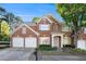 Traditional brick home with a two-car garage, mature landscaping, and a well-maintained front yard at 401 Wellwood Way, Roswell, GA 30075