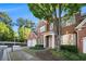 Charming two-story brick home with mature trees, a three-car garage, and inviting front porch at 401 Wellwood Way, Roswell, GA 30075
