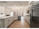 Modern kitchen featuring stainless steel appliances, granite countertops, and ample cabinet space at 401 Wellwood Way, Roswell, GA 30075