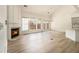 Bright living room with hardwood floors, fireplace, and large windows with natural light at 401 Wellwood Way, Roswell, GA 30075