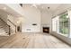 Spacious open-concept living room featuring a fireplace and staircase to the upper level at 401 Wellwood Way, Roswell, GA 30075