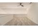Spacious loft area with plush carpet and ceiling fan, perfect for a recreational area at 401 Wellwood Way, Roswell, GA 30075