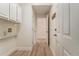 Bright mud room with white cabinets, coat hooks, and wood-look flooring at 401 Wellwood Way, Roswell, GA 30075